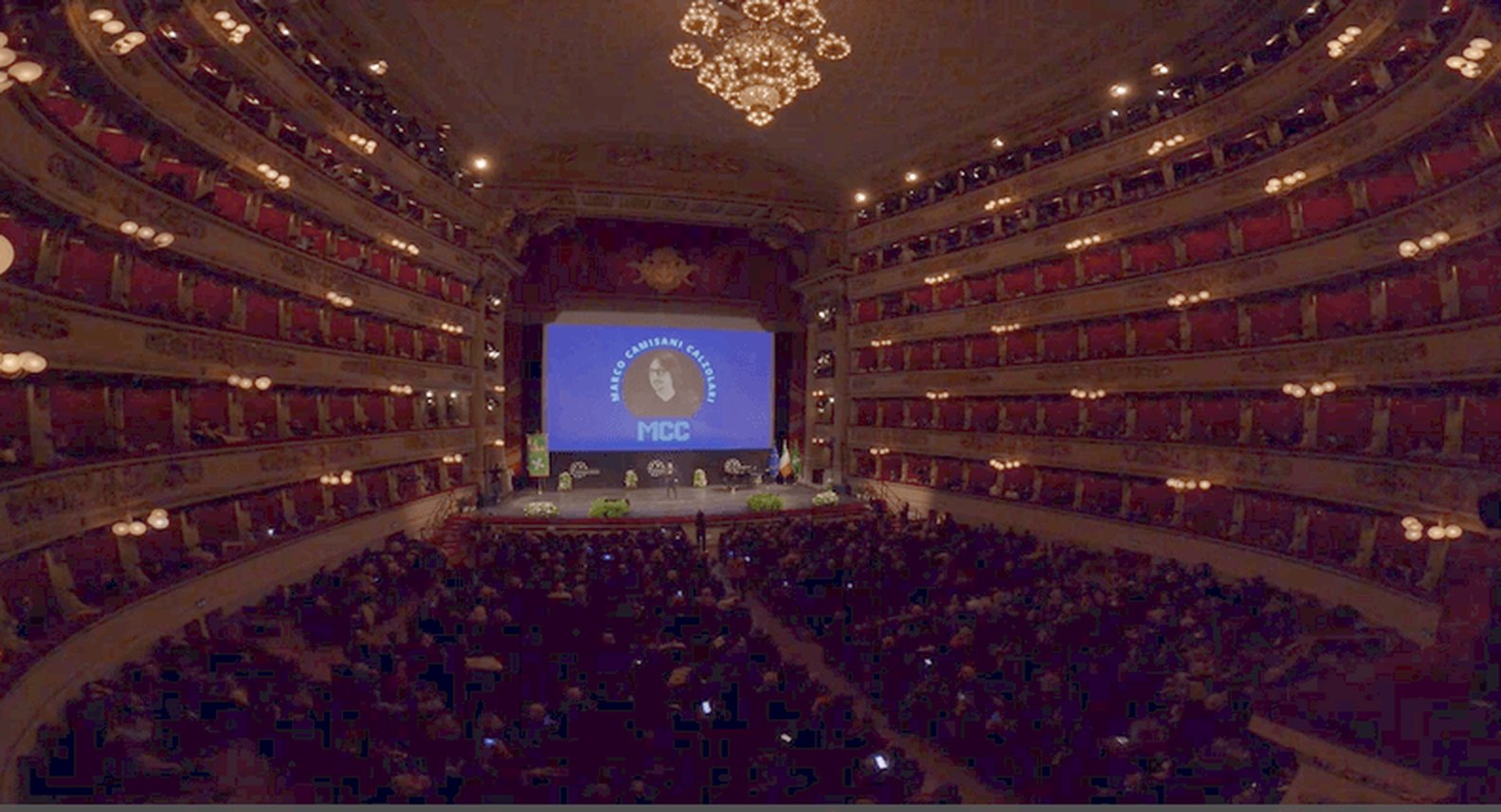 Marco Camisani Calzolari on stage at Teatro alla Scala in Milan, full house